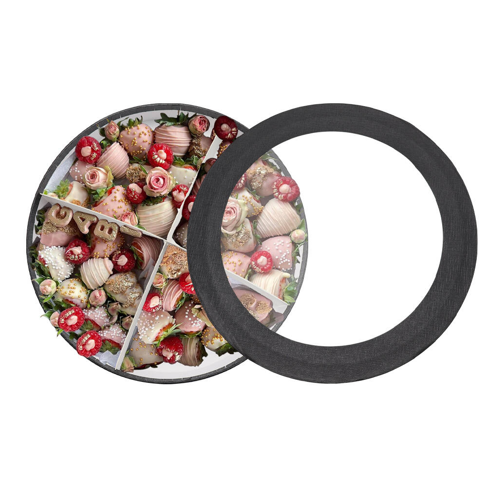 Round charcuterie tray filled with chocolate strawberries, raspberries, and roses